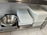 a stainless steel counter with a bowl and a pan on it