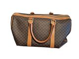 a brown and black handbag on a white background