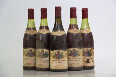 four bottles of wine are lined up on a table