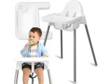 a baby sitting in a high chair with a pacifier in his mouth