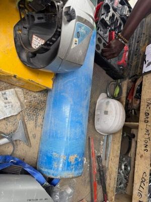a man standing next to a pile of assorted items