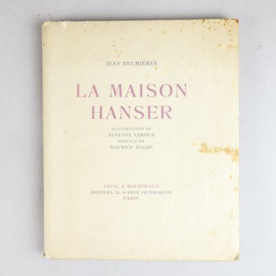an old book with a pink cover on a white surface