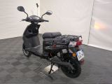 a scooter parked in a room with a checkered floor