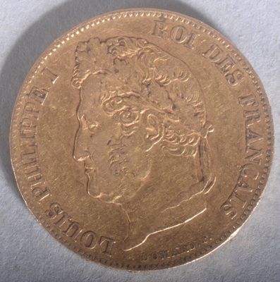 a close up of a gold coin with a woman ' s face on it