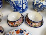 a table with a lot of blue and white dishes and cups and saucers