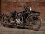 a old motorcycle that is parked in front of a brick wall