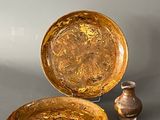 two bowls and a vase sitting on a table