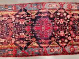 an old persian rug is displayed on a white surface