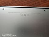 a close up of the back of a laptop on a wooden table