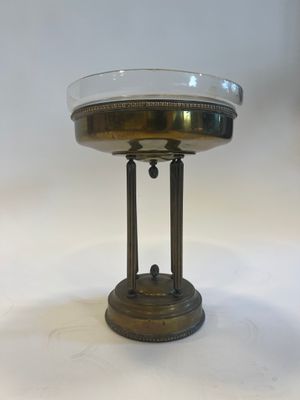 a small table with a glass bowl on top of it