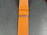 an image of a brown leather watch strap with a red box