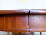 a close up of a wooden table with a drawer underneath it