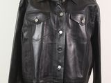 une veste en cuir noir sur un mannequin, sur fond blanc