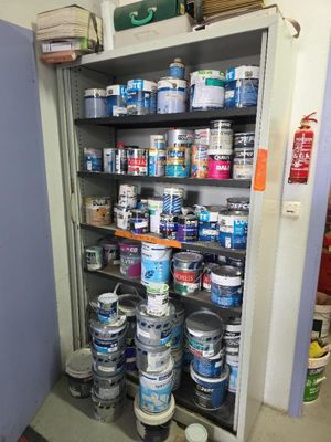 many cans of paint and cans of paint on the shelves