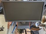 a computer monitor sitting on top of a desk