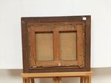a small wooden easel with a painting on it