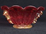 an image of a red glass bowl on a black background