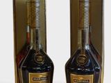 two bottles of liquor are sitting next to each other on a table
