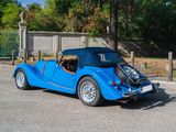 a blue car that is parked in a parking lot
