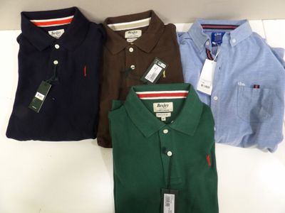 four polo shirts are lined up on a shelf in a store