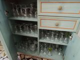 a cabinet that has a bunch of wine glasses in it