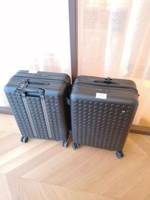 two pieces of luggage sitting next to each other on the floor