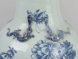 a blue and white vase with a dragon on it
