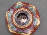 a picture of a ceramic object with a hole in the middle