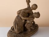 statue of a man and a woman on a boat with a dog