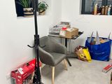 a room with a chair, a table, and a window