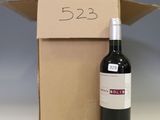 a bottle of wine sitting next to a cardboard box