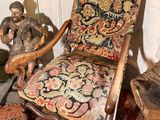 a chair that is sitting in a room with a rug on the floor