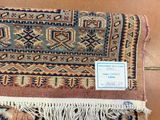 an old rug with a tag on it sitting on the floor