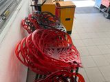 many red chairs lined up on the side of a building
