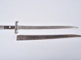 two knives are laying side by side on a white surface