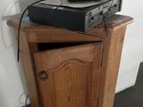 a wooden cabinet with a stereo system on top of it