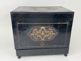an old black box with a decorative design on the front