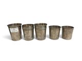 four metal cups sitting next to each other on a white surface