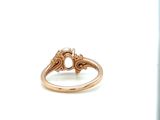 an image of a gold ring with a diamond center