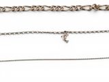 a group of four different chains on a white surface