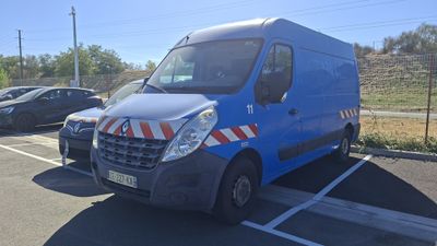 a blue van that is parked in a parking lot