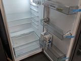 a refrigerator with its door open in a kitchen