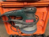 a sander that is sitting on top of an orange box