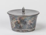an image of a metal container with a lid on a white background