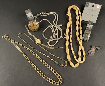a group of jewelry including a watch, bracelets, and a necklace
