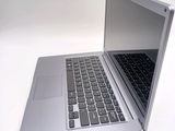 a silver laptop computer sitting on top of a white table