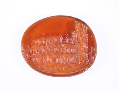 un objet en verre brun sur lequel est représenté un bâtiment