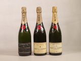 three bottles of champagne sitting next to each other on a table