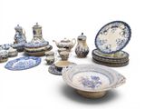 several pieces of blue and white pottery are arranged on a white surface