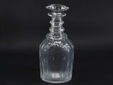a clear glass bottle with a stopper on top of it